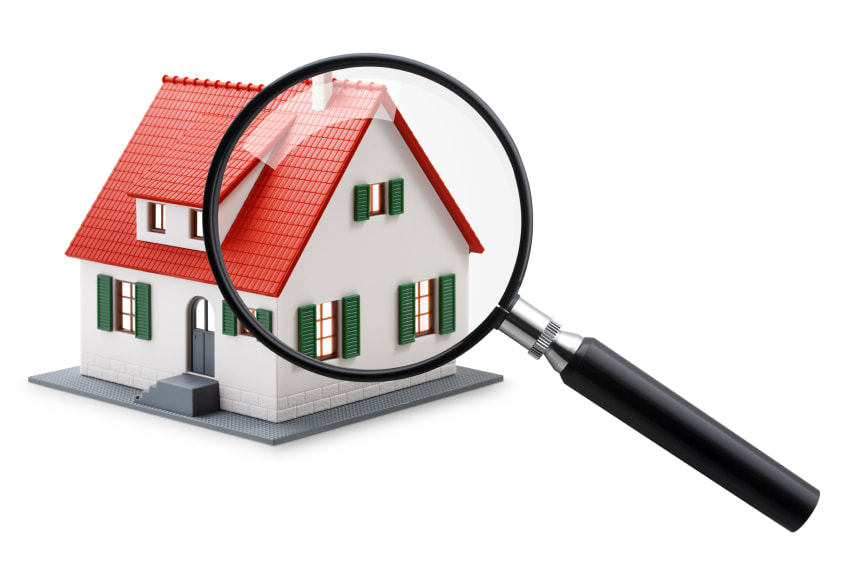 Illustration of a house being examined with a magnifying glass, representing property inspection services.